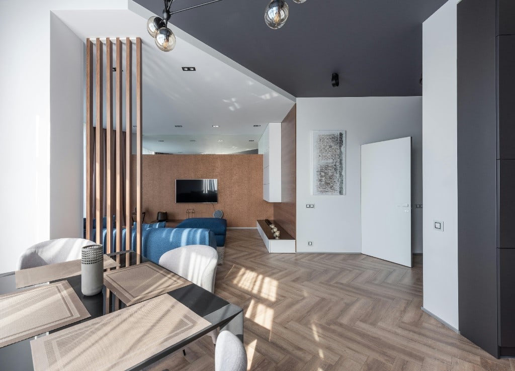 Bright living room with dark hardwood flooring, large windows and natural light