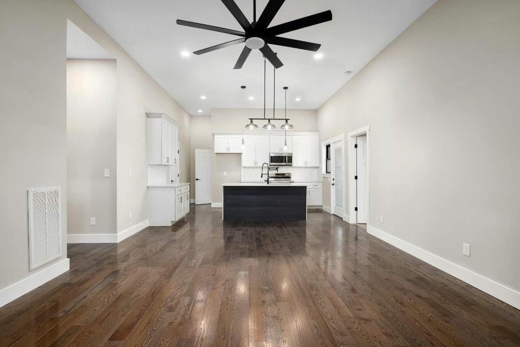 Open-plan living and dining with light herringbone wood flooring and contemporary furniture